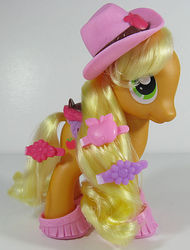 Size: 456x599 | Tagged: safe, photographer:breyer600, applejack, earth pony, pony, g4, fashion style, female, hairclip, hat, irl, mare, photo, saddle, solo, tack, toy