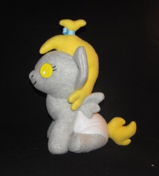 Size: 1926x2124 | Tagged: safe, artist:gypmina, derpy hooves, pegasus, pony, g4, baby, baby pony, black background, female, filly, irl, photo, plushie, side view, simple background, sitting, solo