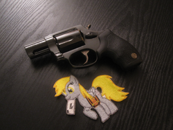 Size: 844x633 | Tagged: safe, derpy hooves, pegasus, pony, g4, barely pony related, female, gun, mare, patch, revolver