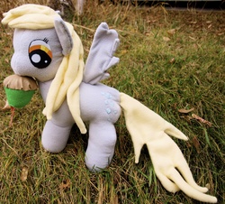 Size: 3027x2736 | Tagged: safe, artist:agony-roses, derpy hooves, pegasus, pony, g4, female, irl, mare, muffin, open mouth, outdoors, photo, plushie, solo, spread wings, wings