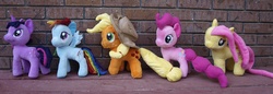 Size: 3551x1222 | Tagged: safe, artist:agony-roses, applejack, fluttershy, pinkie pie, rainbow dash, twilight sparkle, earth pony, pegasus, pony, unicorn, g4, brick wall, irl, modified, outdoors, photo, plushie, unicorn twilight