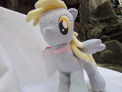 Size: 4320x3240 | Tagged: safe, artist:buttsnstuff, derpy hooves, pegasus, pony, g4, bow, female, irl, mare, outdoors, paper, photo, plushie, solo