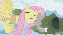 Size: 1280x720 | Tagged: safe, screencap, fluttershy, pegasus, pony, rabbit, g4, my little pony: friendship is magic, season 1, winter wrap up, female, mare, nuzzling, snuggling, winter wrap up song, winter wrap up vest