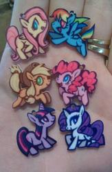 Size: 299x459 | Tagged: safe, artist:purplekecleon, applejack, fluttershy, pinkie pie, rainbow dash, rarity, twilight sparkle, earth pony, pegasus, pony, unicorn, g4, anime expo, closed mouth, female, flying, hand, irl, jewelry, jumping, mane six, mare, open mouth, open smile, photo, raised hoof, ring, smiling, toy, walking