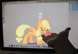 Size: 1140x796 | Tagged: dead source, safe, artist:egophiliac, applejack, human, g4, apple, computer, eyes closed, fourth wall, hand, irl, irl human, mac os, mac os x, photo, ponies in real life, tongue out