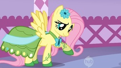 Size: 1044x587 | Tagged: safe, screencap, fluttershy, pegasus, pony, g4, suited for success, carousel boutique, clothes, dress, gala dress, hub logo, logo, scrunchy face, solo, the hub