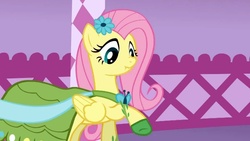 Size: 923x520 | Tagged: safe, screencap, fluttershy, pegasus, pony, g4, my little pony: friendship is magic, suited for success, carousel boutique, clothes, dress, female, gala dress, scrunchy face, solo