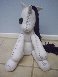 Size: 3000x4000 | Tagged: safe, artist:charletothemagne, rarity, pony, unicorn, g4, creepy, female, horn, irl, mare, missing eye, photo, plushie, sitting, solo, stitched body