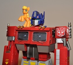 Size: 532x474 | Tagged: safe, applejack, earth pony, pony, g4, blind bag, irl, optimus prime, photo, toy, transformers