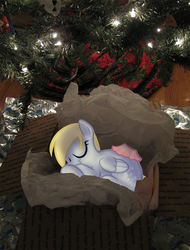 Size: 900x1184 | Tagged: safe, artist:egophiliac, derpy hooves, pegasus, pony, g4, christmas, christmas tree, cute, daaaaaaaaaaaw, eyes closed, female, mare, on side, present, sleeping, smiling, solo, tree, was muffins, wrapper