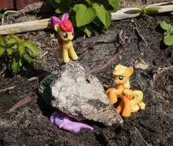 Size: 891x750 | Tagged: safe, apple bloom, applejack, diamond tiara, g4, abuse, blind bag, boulder, crushing, imminent death, irl, murder, outdoors, photo, rock, tiarabuse, toy, toy abuse, witch trials