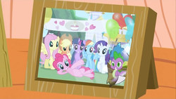 Size: 1280x720 | Tagged: safe, screencap, applejack, fluttershy, pinkie pie, rainbow dash, rarity, spike, twilight sparkle, dragon, earth pony, pegasus, pony, unicorn, dragon quest, g4, sweet and elite, birthday, female, grin, heart, male, mane seven, mane six, mare, on side, party, photo, picture, picture frame, raised hoof, smiling, squee, the saddest picture in equestria, unicorn twilight, waving