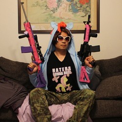 Size: 612x612 | Tagged: safe, fluttershy, human, g4, brony, clothes, gun, hoodie, irl, irl human, photo, shirt