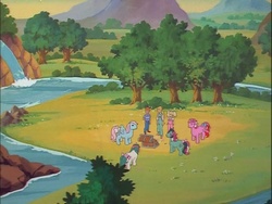 Size: 718x540 | Tagged: safe, screencap, danny williams, fizzy, galaxy (g1), gusty, megan williams, molly williams, wind whistler, human, twinkle eyed pony, g1, my little pony 'n friends, mountain, river, scenery, treasure chest, tree, valley