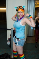 Size: 1365x2048 | Tagged: safe, artist:geekeryandsuch, rainbow dash, human, g4, big breasts, breasts, busty rainbow dash, cosplay, flexing, irl, irl human, photo, rainboob dashie ali, san diego comic con, solo