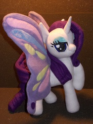 Size: 2736x3648 | Tagged: safe, artist:mantaro85, rarity, butterfly, g4, artificial wings, augmented, glimmer wings, irl, magic, magic wings, photo, plushie, solo, wings