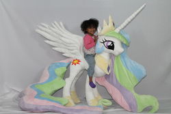 Size: 1600x1066 | Tagged: safe, artist:karasunezumi, princess celestia, alicorn, human, pony, g4, duo, humans riding ponies, irl, irl human, life size, photo, plushie, riding, sitting on person, sitting on pony, size comparison, spread wings, target demographic, wings