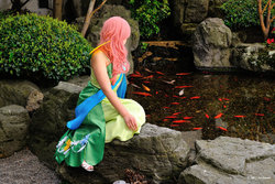 Size: 1024x682 | Tagged: safe, artist:areihanai, fluttershy, fish, human, g4, animal, animation on display, clothes, cosplay, dress, gala dress, garden, irl, irl human, photo, solo, water