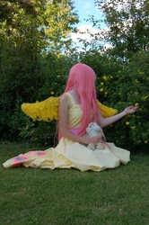 Size: 2000x3008 | Tagged: safe, artist:hebiriyu, fluttershy, human, g4, cosplay, flower, grass, irl, irl human, kneeling, outdoors, photo, plushie, solo