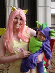 Size: 768x1024 | Tagged: safe, fluttershy, spike, human, g4, baby, clothes, cosplay, dragon con, dragon con 2011, irl, irl human, kigurumi, onesie, photo
