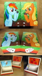 Size: 1000x1812 | Tagged: safe, artist:atelok, applejack, rainbow dash, g4, box, card, cutie mark, photo, table