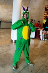 Size: 1362x2048 | Tagged: safe, artist:gavinclinton, crackle, dragon, human, g4, clothes, convention, cosplay, irl, irl human, kigurumi, london mcm expo, onesie, photo