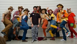 Size: 2048x1169 | Tagged: artist needed, safe, apple bloom, applejack, big macintosh, braeburn, human, g4, cosplay, cowboy vest, group photo, irl, irl human, london mcm expo, london mcm oct 2012 expo, overalls, photo, suspenders