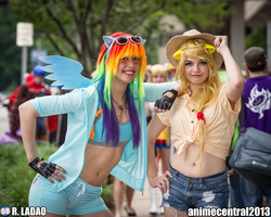 Size: 2047x1638 | Tagged: safe, artist:okicospi, artist:peachypossum, applejack, rainbow dash, human, g4, anime central, anime central 2013, belly button, belly piercing, bellyring, clothes, cosplay, fingerless gloves, front knot midriff, gloves, irl, irl human, midriff, photo, piercing, shorts, sunglasses