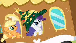 Size: 960x540 | Tagged: safe, screencap, applejack, rarity, g4, hearth's warming eve (episode), and then there's rarity, christmas tree, giant hat, hat, hearth's warming eve