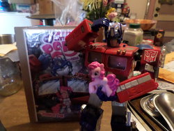 Size: 1024x768 | Tagged: safe, idw, pinkie pie, g4, comic, female, irl, merchandise, optimus prime, photo, toy, transformers