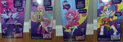 Size: 1774x618 | Tagged: safe, fluttershy, pinkie pie, rainbow dash, twilight sparkle, equestria girls, g4, my little pony equestria girls: rainbow rocks, box art, devil horn (gesture), doll, female, glam, high heels, irl, photo, rainbow dash always dresses in style, toy