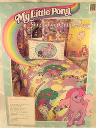 Size: 576x768 | Tagged: safe, photographer:kisscurl, light heart, sweet berry, earth pony, pony, g2, bedspread, female, looking at you, mare, merchandise, photo, rainbow