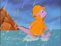 Size: 640x480 | Tagged: safe, screencap, spike (g1), g1, my little pony 'n friends, the magic coins, rain, raincoat, walking on water, water