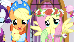 Size: 1280x720 | Tagged: safe, screencap, applejack, fluttershy, earth pony, pegasus, pony, unicorn, g4, magical mystery cure, clothes, crying, dress, duo focus, female, floral head wreath, flower, happy, hub logo, logo, mare, offscreen character, spread wings, tears of joy, the hub, wings