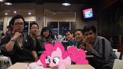 Size: 960x540 | Tagged: safe, derpy hooves, pinkie pie, chicken, human, g4, food, fourth wall pose, glasses, indonesia, irl, irl human, meat, photo, ponies eating meat, ponies in real life