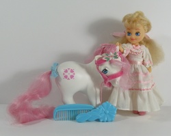 Size: 700x558 | Tagged: safe, photographer:breyer600, sundance, g1, bow, bridle, brush, clothes, comb, dress, frilly dress, irl, photo, tack, tail, tail bow, toy