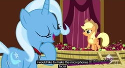 Size: 639x350 | Tagged: safe, screencap, applejack, trixie, g4, magic duel, apple, microphone, wtf, youtube caption