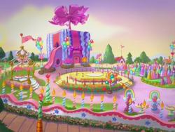 Size: 640x480 | Tagged: safe, screencap, g3, positively pink, birthday park, funhouse, gate, gazebo, no pony, park, party cake place, ponyville, present, slide, stage, tent, tree