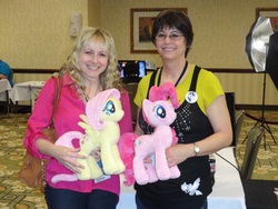Size: 2592x1944 | Tagged: safe, artist:whitedove-creations, fluttershy, pinkie pie, rarity, human, g4, andrea libman, bag, button, convention, glasses, happy, irl, irl human, nerdkon, photo, plushie, smiling, voice actor