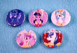 Size: 907x622 | Tagged: dead source, safe, princess cadance, princess celestia, princess luna, shining armor, twilight sparkle, alicorn, pony, g4, button, female, mare, merchandise, twilight sparkle (alicorn)