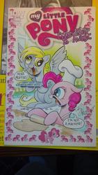 Size: 1024x1816 | Tagged: safe, artist:andypriceart, idw, derpy hooves, pinkie pie, earth pony, pegasus, pony, g4, angry, baking, comic cover, dough, female, irl, little tongue, mare, my little pony logo, photo, traditional art