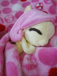 Size: 2346x3128 | Tagged: safe, artist:fallenpeach, fluttershy, pony, g4, blanket, cute, eyes closed, irl, on side, photo, plushie, shyabetes, smiling, solo