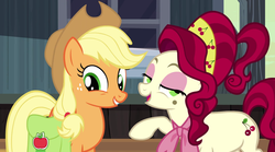 Size: 957x532 | Tagged: safe, screencap, applejack, cherry jubilee, earth pony, pony, g4, the last roundup, cowboy hat, female, grin, hat, hooves, mare, open mouth, saddle bag, smiling