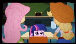 Size: 1016x594 | Tagged: safe, screencap, applejack, fluttershy, twilight sparkle, equestria girls, g4, my little pony equestria girls, chair, classroom, female, hiding, table