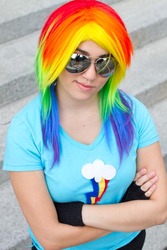 Size: 427x640 | Tagged: safe, artist:magyktrix, rainbow dash, human, g4, clothes, cosplay, crossed arms, fingerless gloves, gloves, irl, irl human, photo, solo, sunglasses