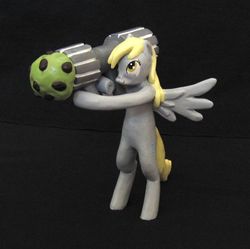 Size: 896x892 | Tagged: safe, derpy hooves, pegasus, pony, g4, cannon ponies, female, figurine, free standing, gileda, mare, muffin, muffin launcher, rocket launcher, sculpture, statue