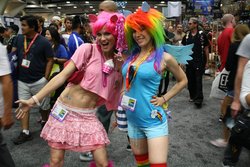 Size: 960x640 | Tagged: artist needed, safe, artist:martindemartian, pinkie pie, rainbow dash, human, g4, belly button, clothes, convention, cosplay, irl, irl human, midriff, photo, skirt