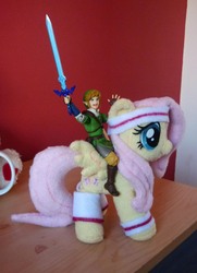 Size: 1254x1730 | Tagged: safe, artist:sophiesplushies, fluttershy, g4, humans riding ponies, irl, link, nintendo, photo, plushie, riding, the legend of zelda