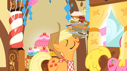 Size: 1054x592 | Tagged: safe, screencap, applejack, cherry berry, earth pony, pony, a bird in the hoof, g4, season 1, apple, apple fritter (food), balancing, caramel apple (food), cupcake, female, food, licking, licking lips, mare, pie, ponies balancing stuff on their nose, solo, solo focus, tongue out