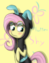 Size: 700x900 | Tagged: safe, artist:sticky-plaster, fluttershy, pegasus, pony, g4, blushing, bunny ears, clothes, costume, cute, cutie mark background, dangerous mission outfit, female, goggles, hoodie, mare, simple background, solo, yellow background